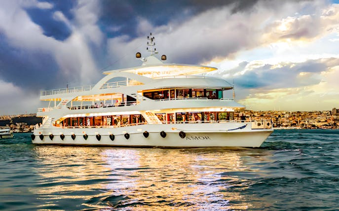 Bosphorus cruise ship sailing with cityscape in the background.