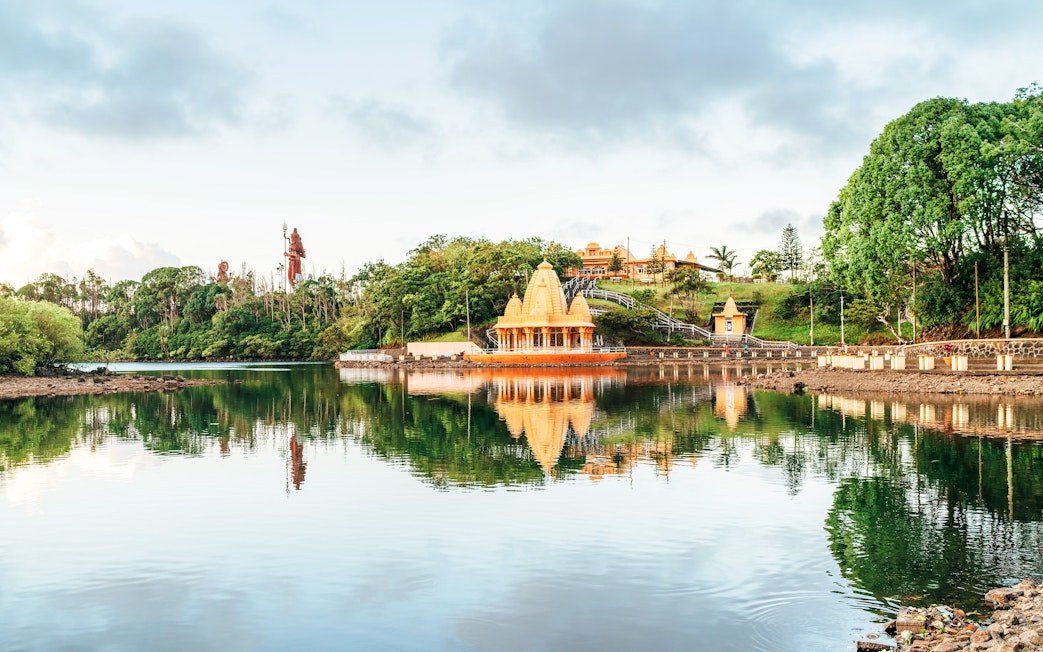 Grand Bassin Temple reflecting in the lake at Ganga Talao, Mauritius.