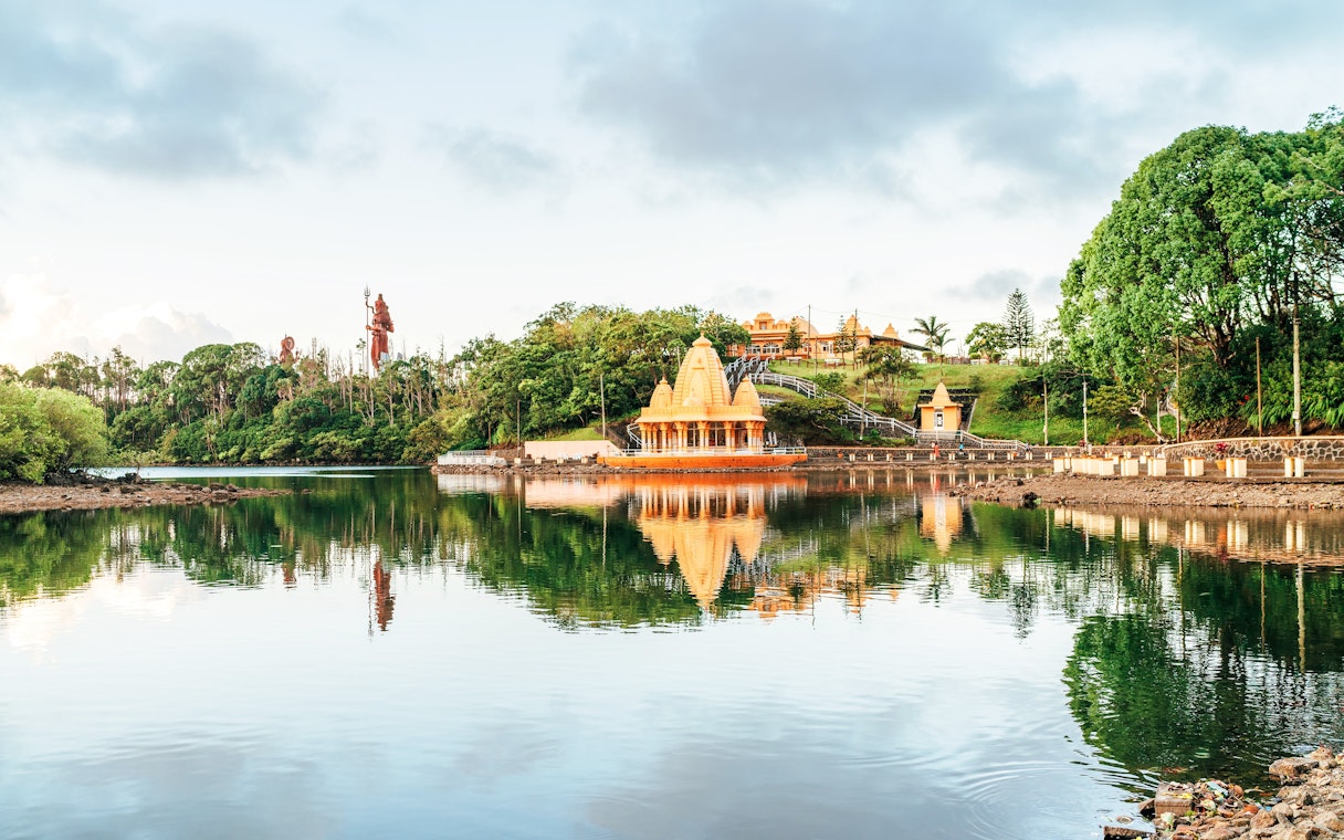 Grand Bassin Temple reflecting in the lake at Ganga Talao, Mauritius.