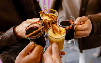 Guests toasting with mulled wine on Budapest Danube River cruise.