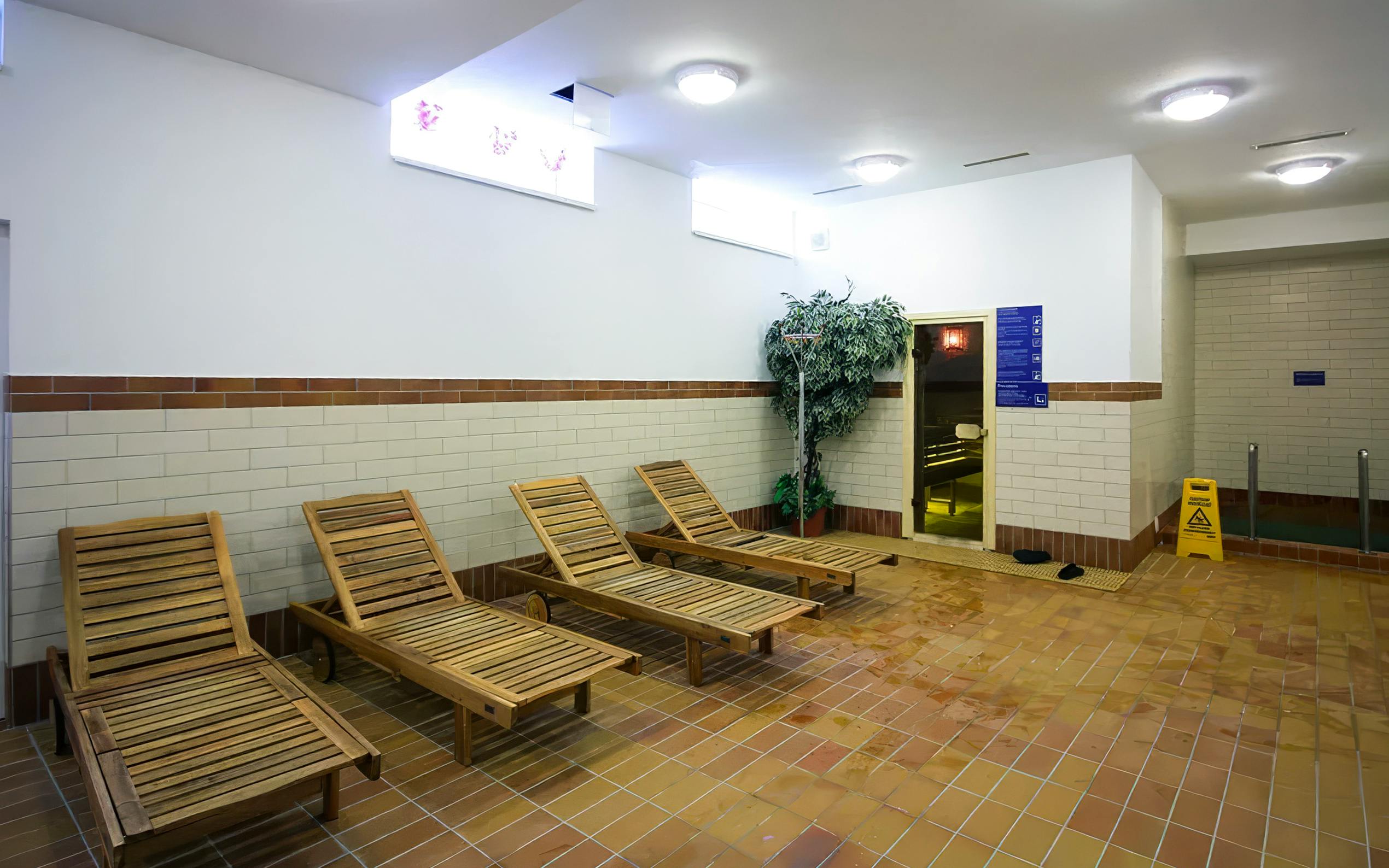 Wooden lounge chairs in the relaxation area of Dandar Spa.