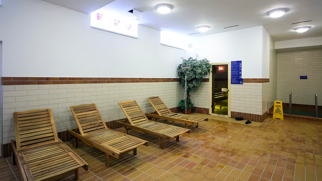 Wooden lounge chairs in the relaxation area of Dandar Spa.