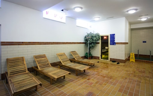 Wooden lounge chairs in the relaxation area of Dandar Spa.