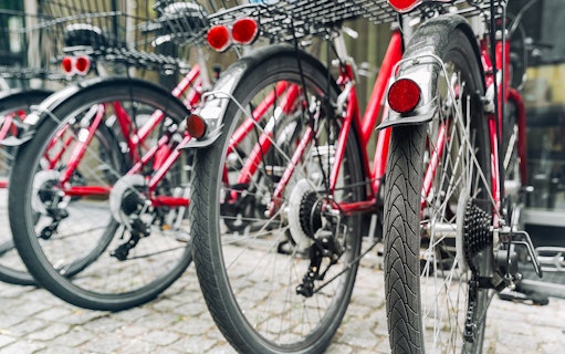 Red bicycles lined up for a guided bike tour in Germany.