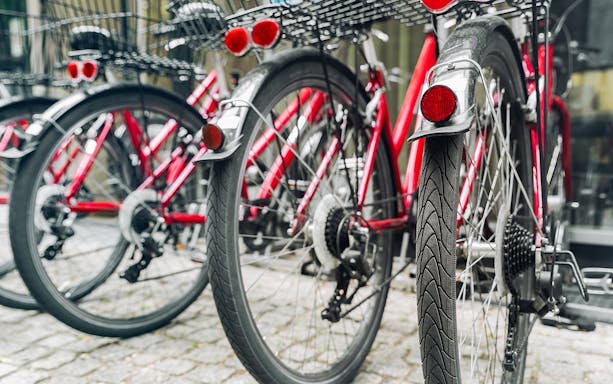 Red bicycles lined up for a guided bike tour in Germany.