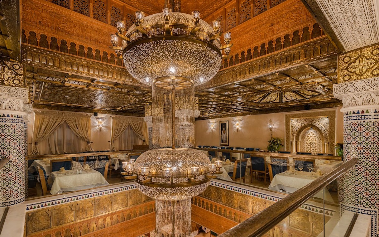 Interior view of a Moroccan restaurant with ornate chandelier and traditional decor in Casablanca, Morocco.
