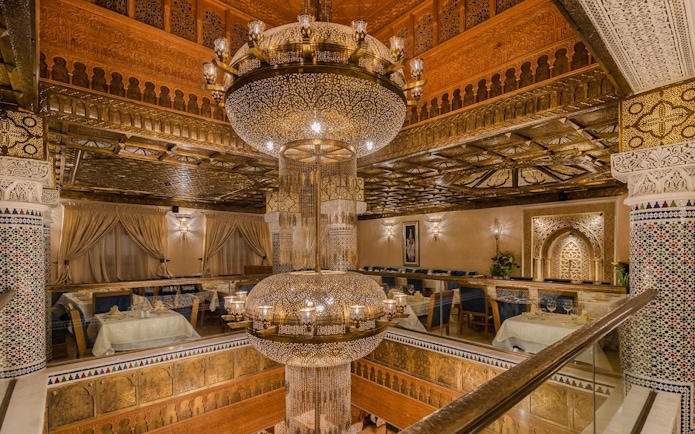 Interior view of a Moroccan restaurant with ornate chandelier and traditional decor in Casablanca, Morocco.