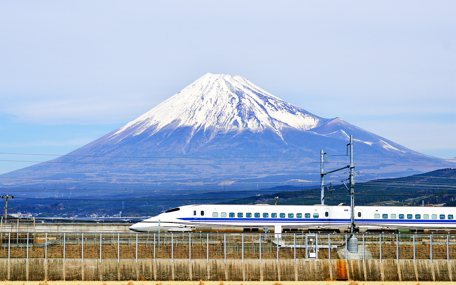 High-speed train passing Mount Fuji, Japan, with JR Pass.
