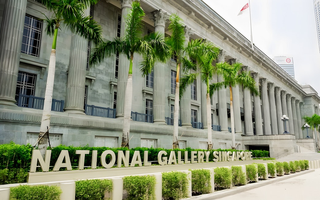 National Gallery Singapore exterior with columns and palm trees.