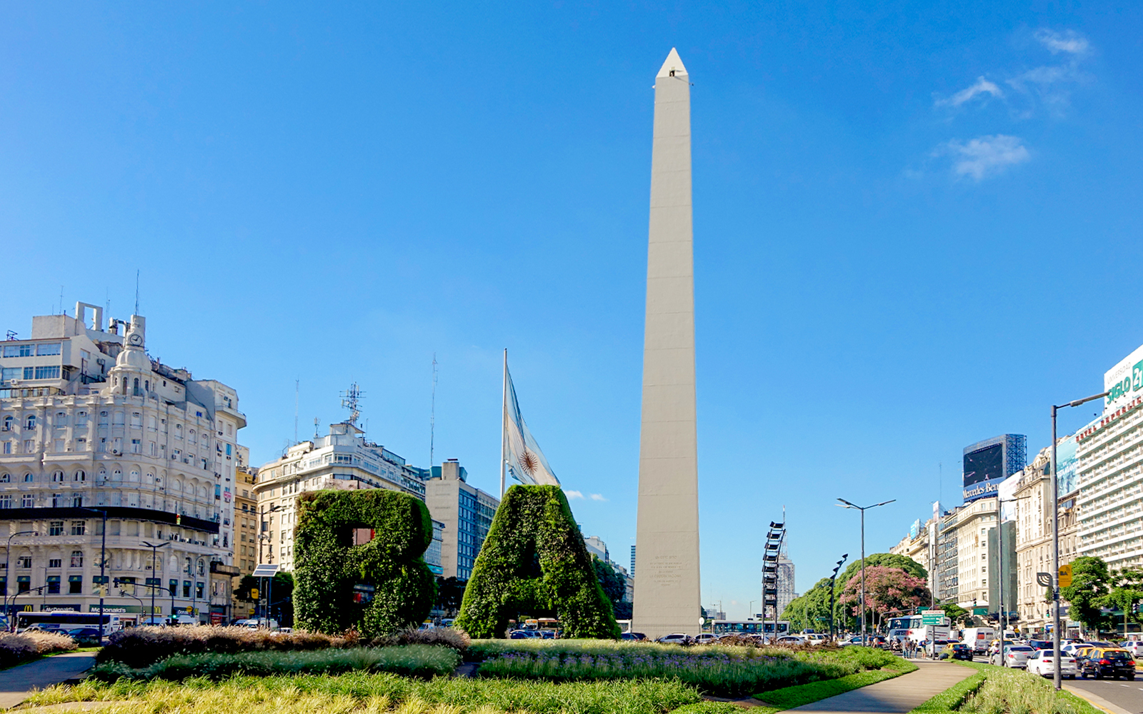 Obelisco de Buenos Aires with surrounding cityscape and greenery in Buenos Aires, Argentina.