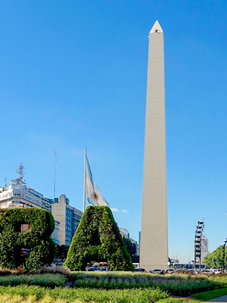 Obelisco de Buenos Aires with surrounding cityscape and greenery in Buenos Aires, Argentina.