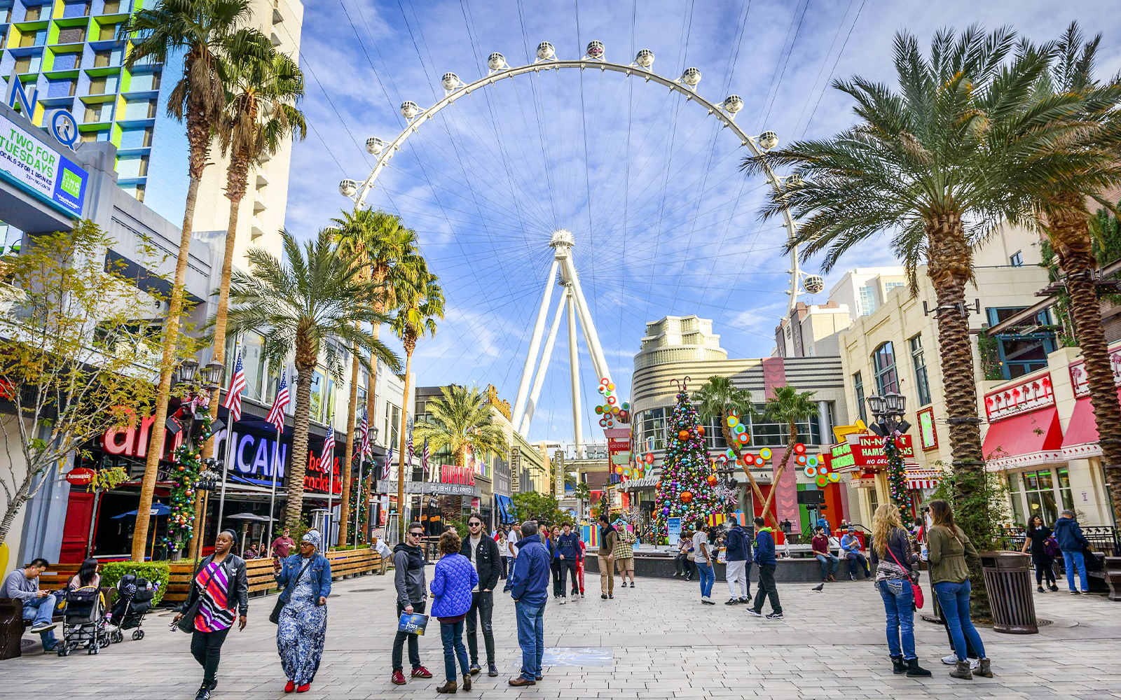 High Roller observation wheel at The LINQ, Las Vegas with people walking below.