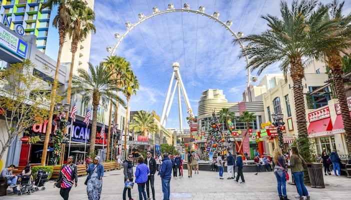 High Roller observation wheel at The LINQ, Las Vegas with people walking below.