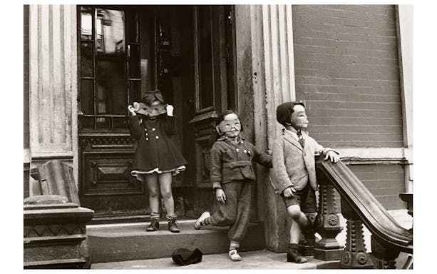 Children wearing masks on a stoop, part of the Women Photographers (1900-1975) exhibition at the National Gallery of Victoria.