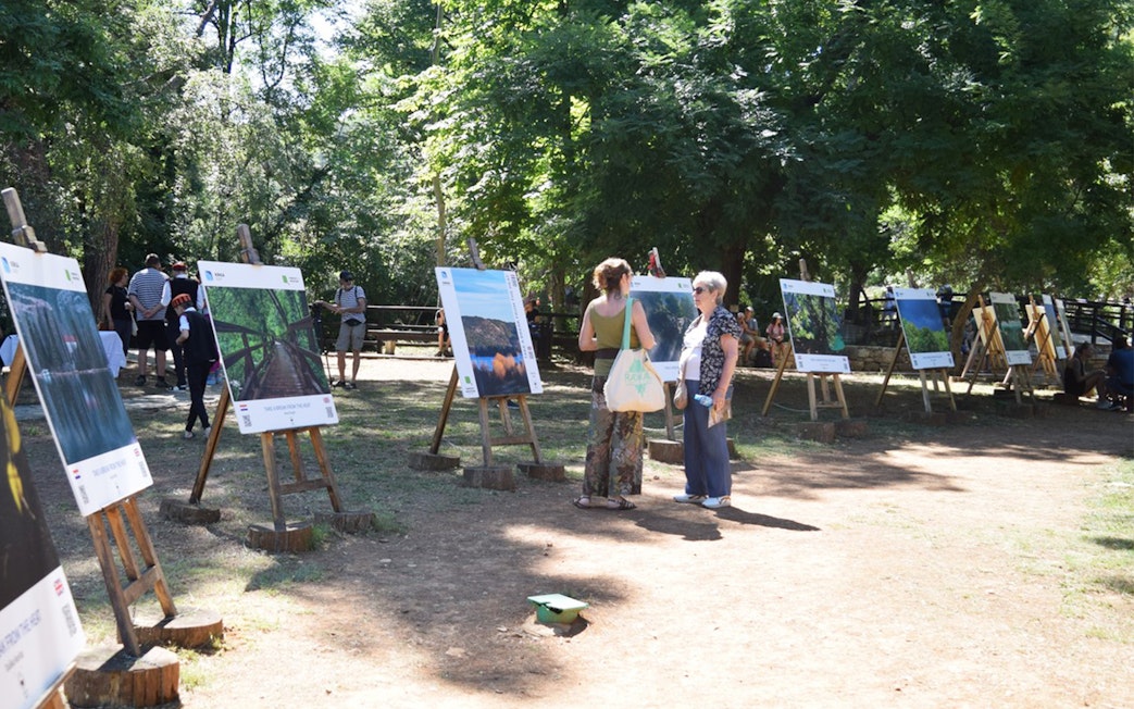 Visitors viewing outdoor exhibits at Krka National Park.