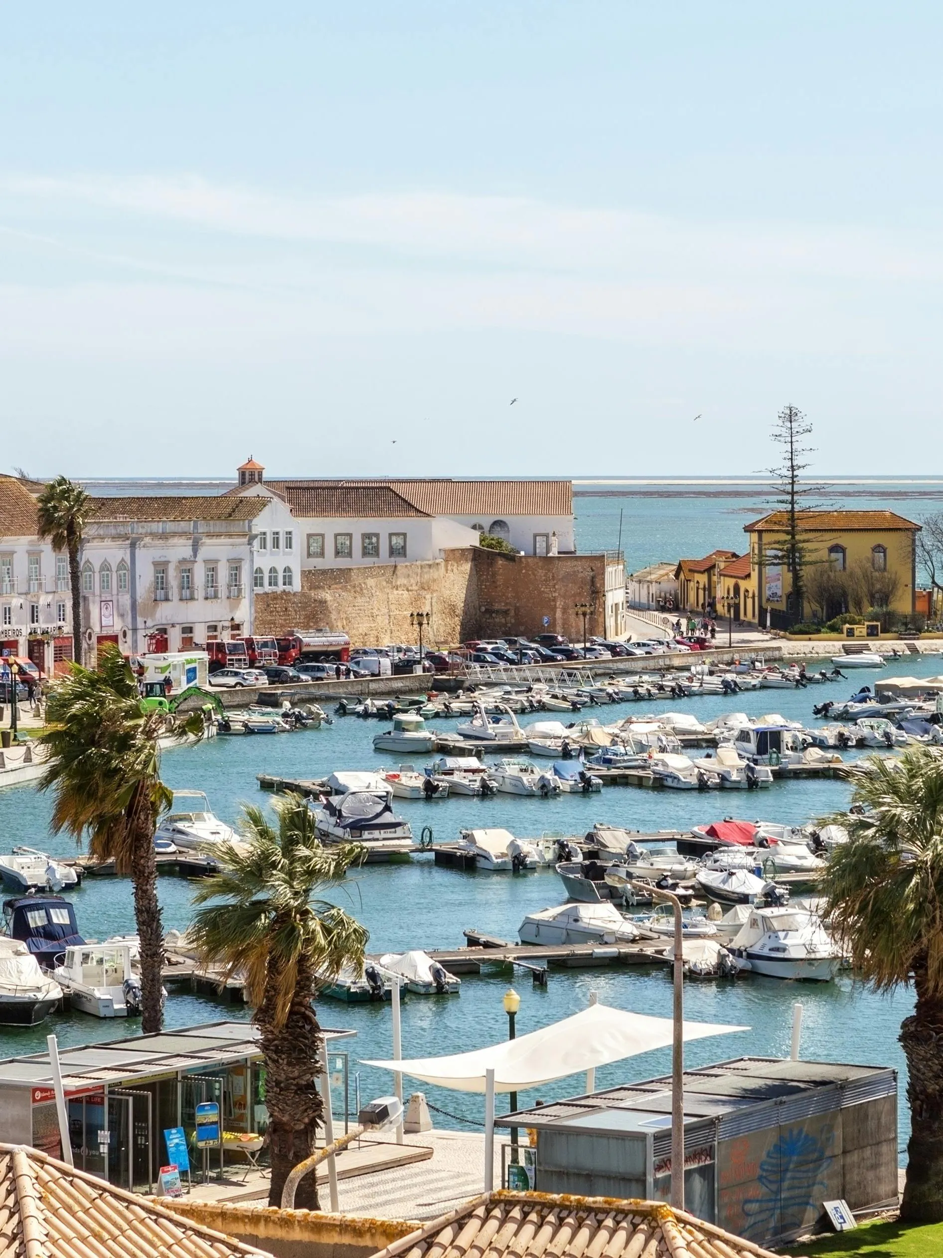 Faro marina view with boats and historic buildings along the waterfront.