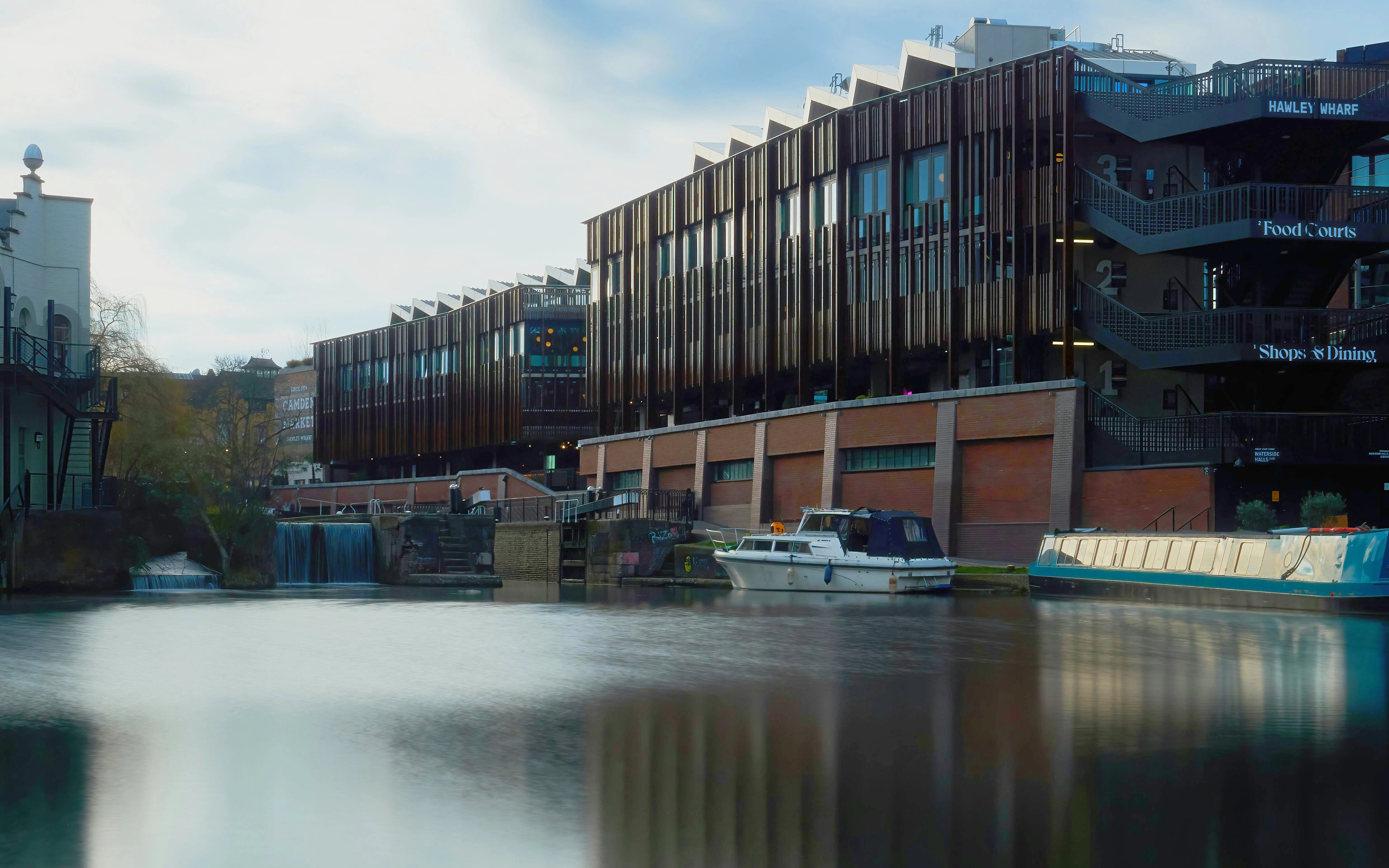 Hawley Wharf London with canal boats and modern buildings along the water.