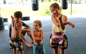 Children practicing Muay Thai moves in a Krabi boxing class.