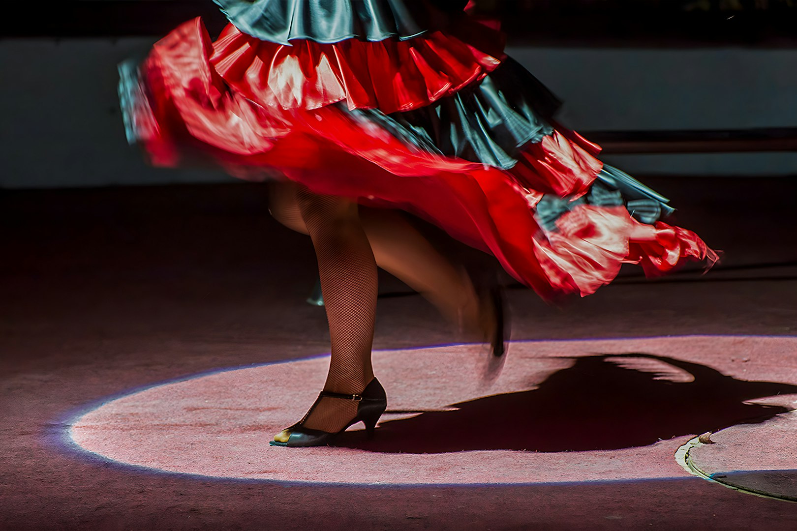 Flamenco dancer's feet in motion at Tablao El Arenal, Seville.