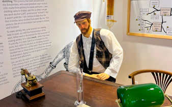 Mannequin in traditional attire at Prague Beer Museum exhibit.