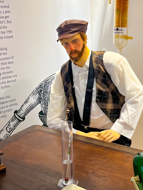 Mannequin in traditional attire at Prague Beer Museum exhibit.
