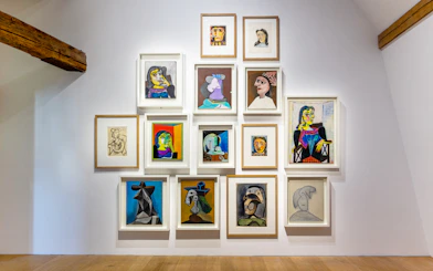 Picasso Museum art display with various framed paintings and sketches.