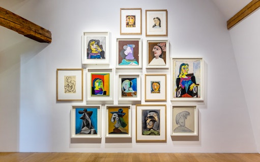 Picasso Museum art display with various framed paintings and sketches.