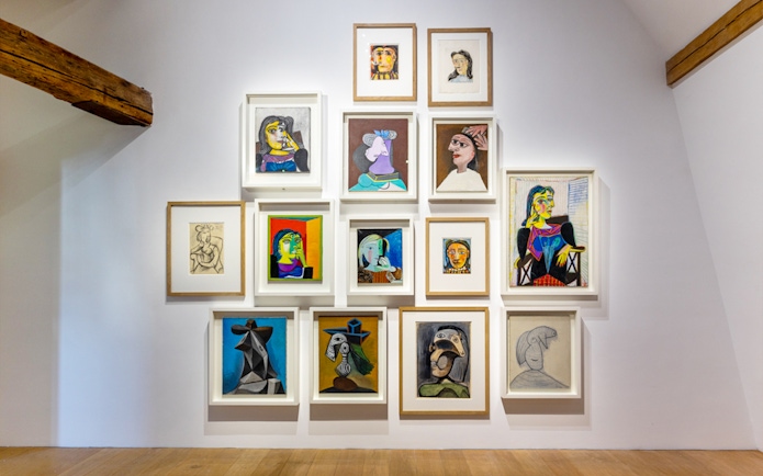 Picasso Museum art display with various framed paintings and sketches.