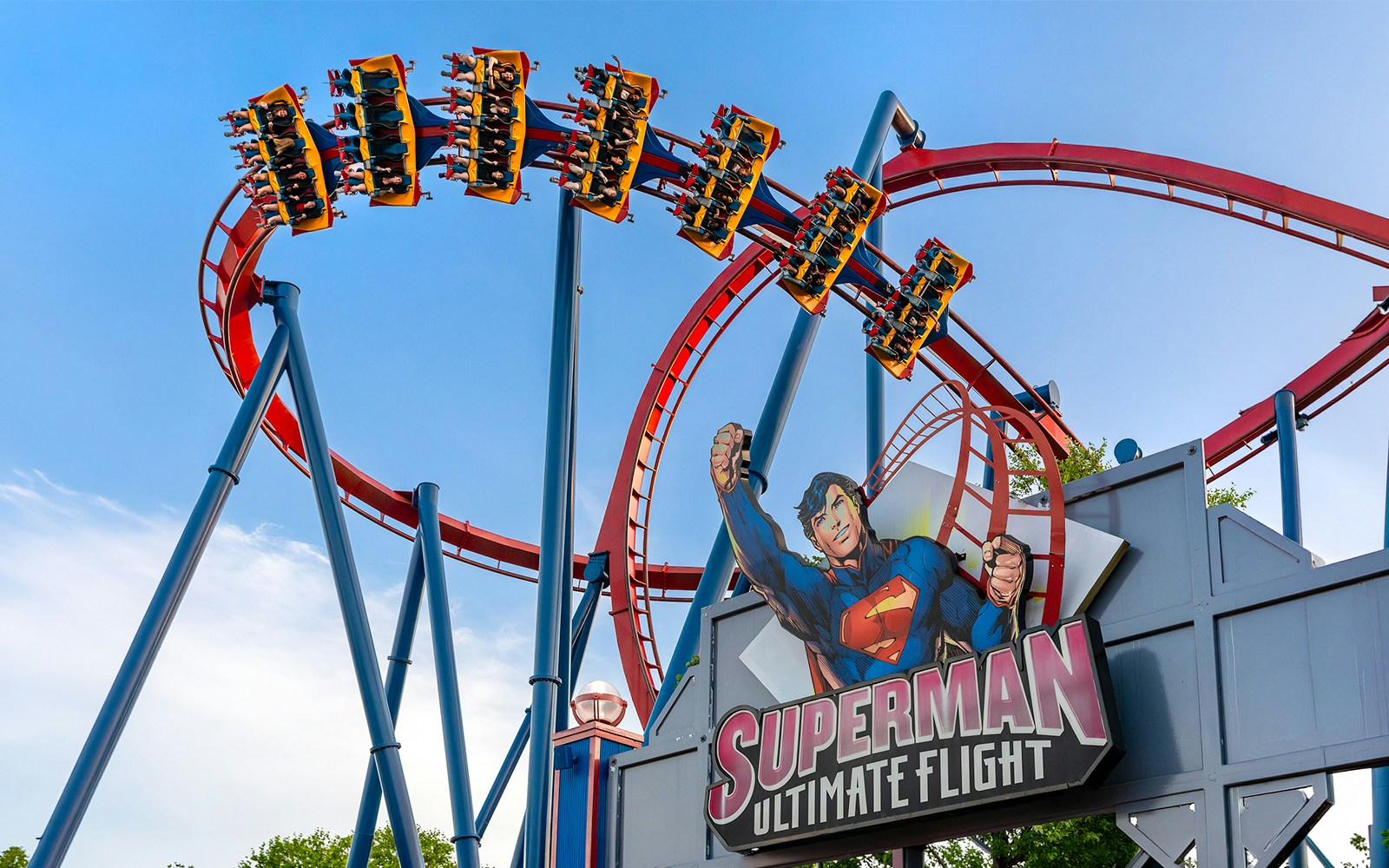 SUPERMAN™ Ultimate Flight roller coaster at Six Flags Over Georgia with riders in mid-air.