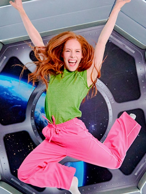 Guest jumping in space-themed room at Paradox Museum London.