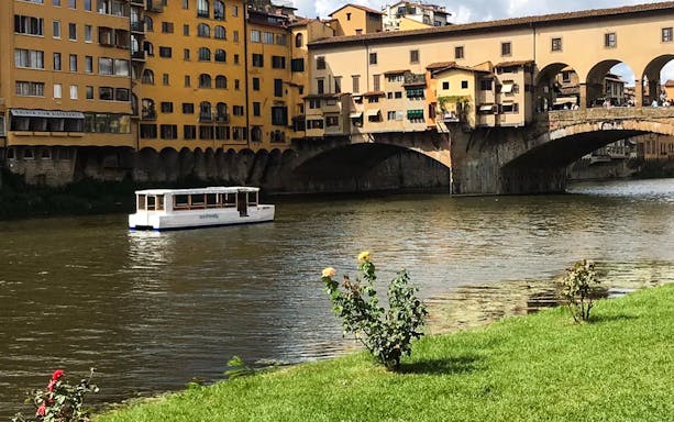 Boat on the Arno River near Ponte Vecchio, Florence, during a 1-hour ride with Tuscan lunch.