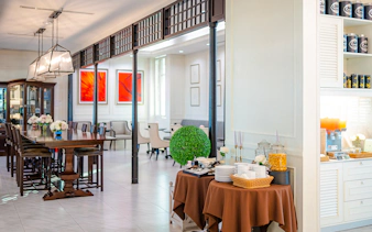 Dining area at The Coral Executive Lounge, Bangkok Airport, featuring a buffet setup.