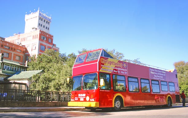 Red double-decker bus on San Antonio Hop-On-Hop-Off Tour near Pioneer Flour Mill.