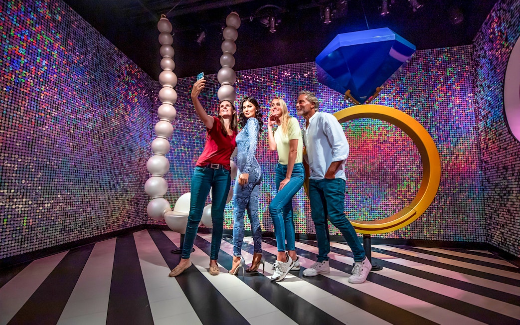 Visitors taking a selfie with Kylie Jenner wax figure at Madame Tussauds Dubai.