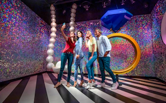 Visitors taking a selfie with Kylie Jenner wax figure at Madame Tussauds Dubai.