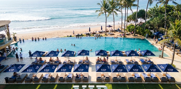 VIP area at Finn's Beach Club with poolside loungers and ocean view in Bali.