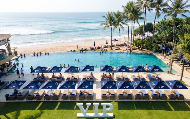 VIP area at Finn's Beach Club with poolside loungers and ocean view in Bali.