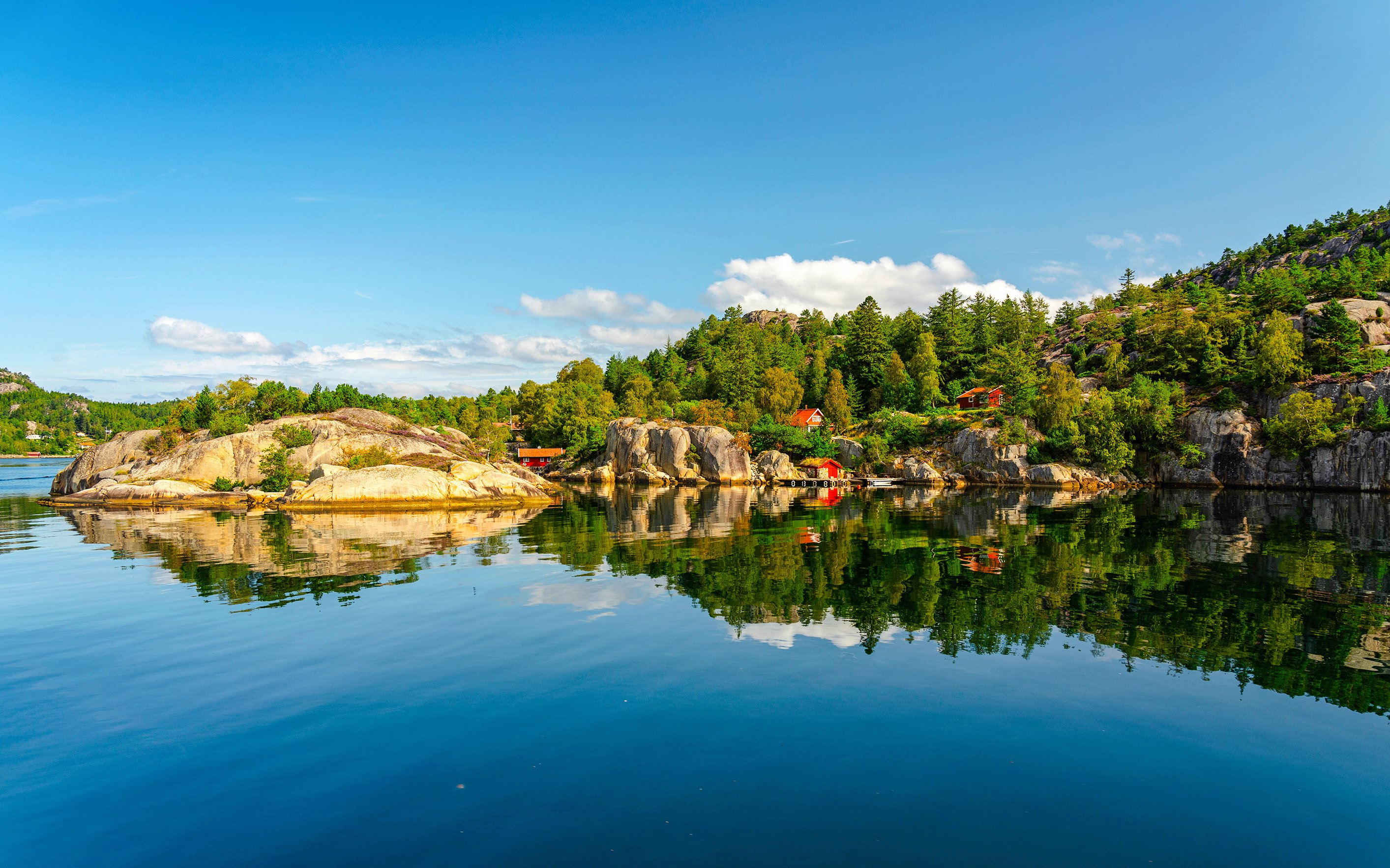 Lysefjord landscape with rocky shores and forested hills, Norway.