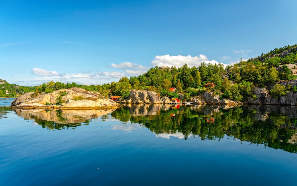 Lysefjord landscape with rocky shores and forested hills, Norway.
