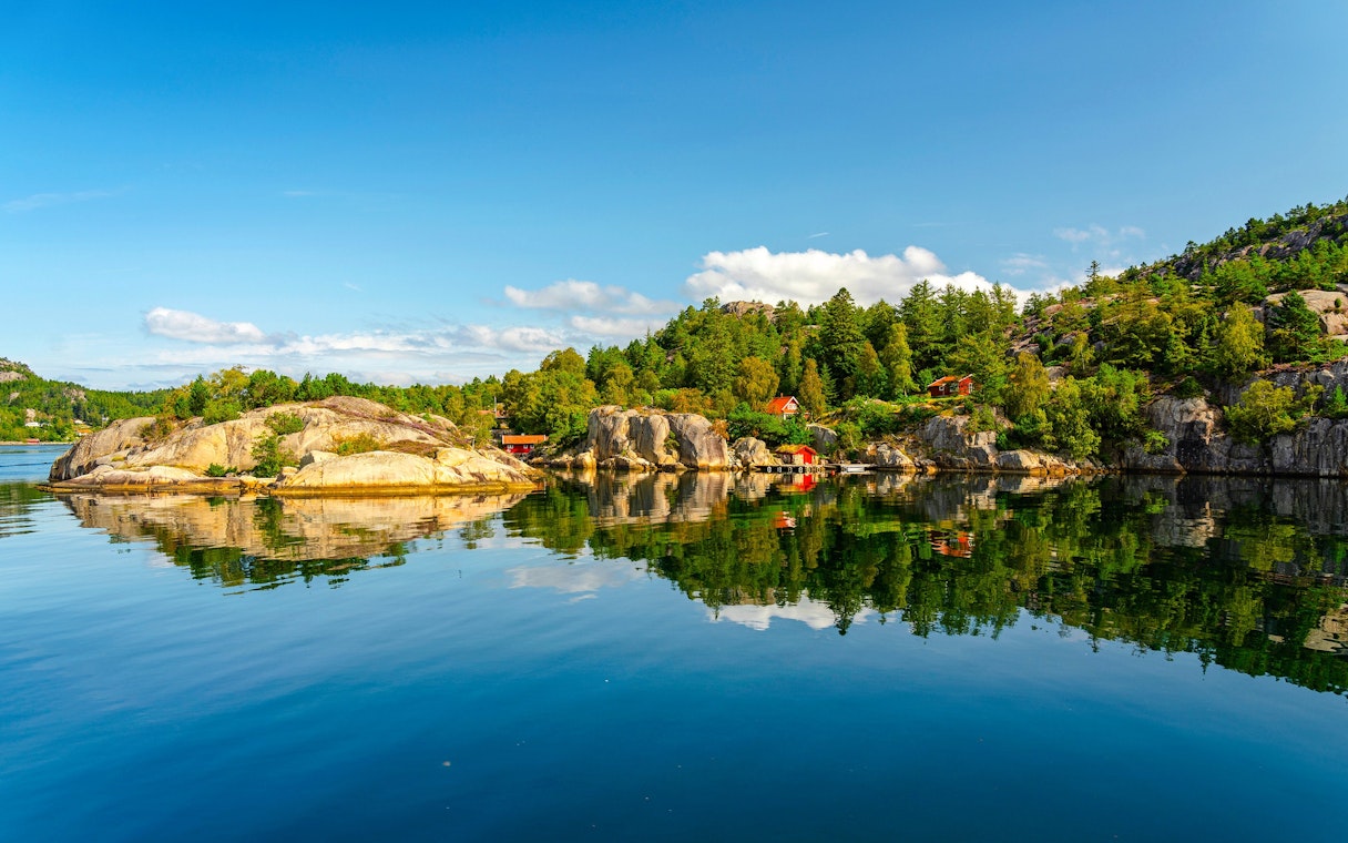 Lysefjord landscape with rocky shores and forested hills, Norway.