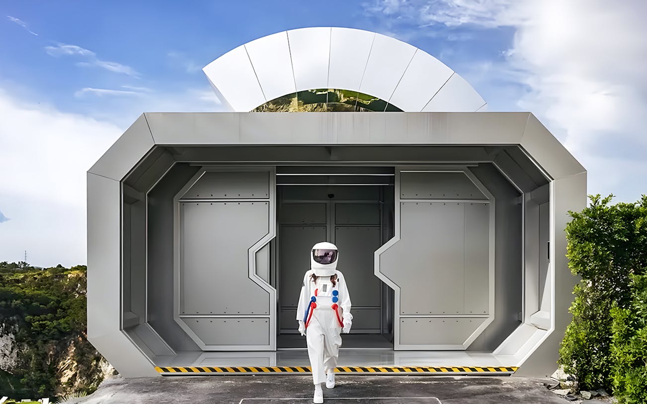 Astronaut exiting futuristic building at LOF LAND attraction.