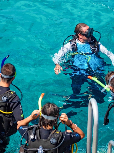 Tourists and instructor preparing to dive in Outer Great Barrier Reef.