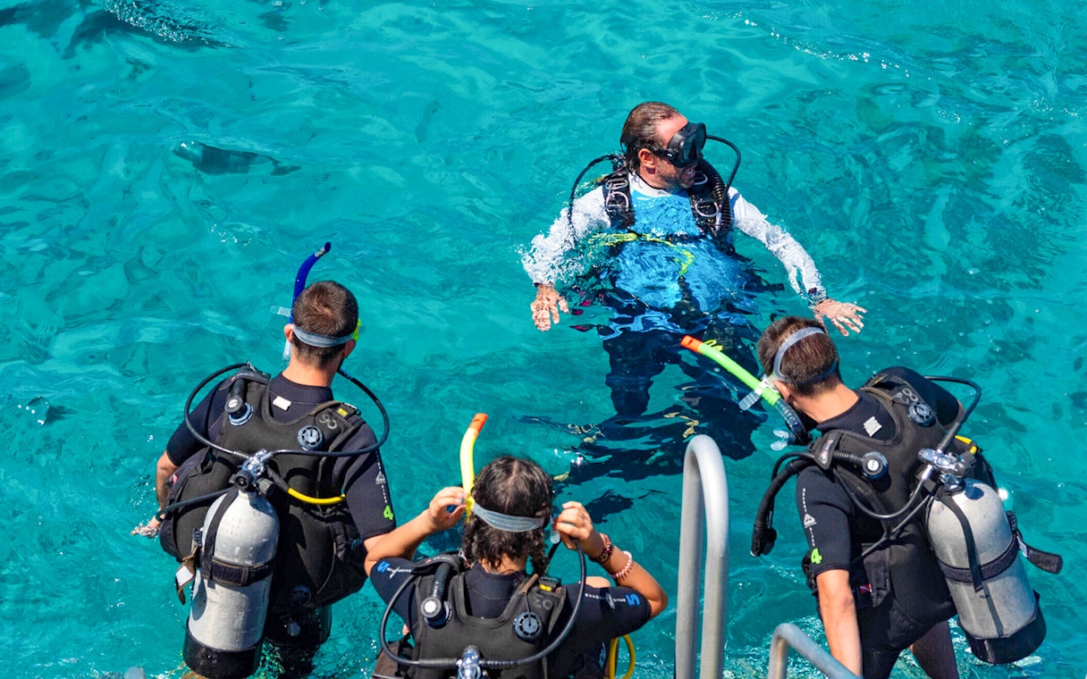 Tourists and instructor preparing to dive in Outer Great Barrier Reef.