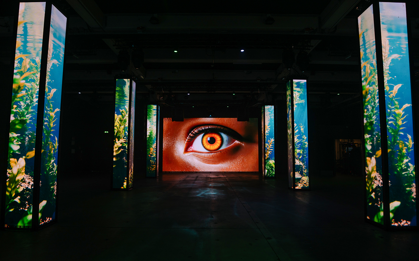 Interactive digital art installation with eye display at Amaze Amsterdam.