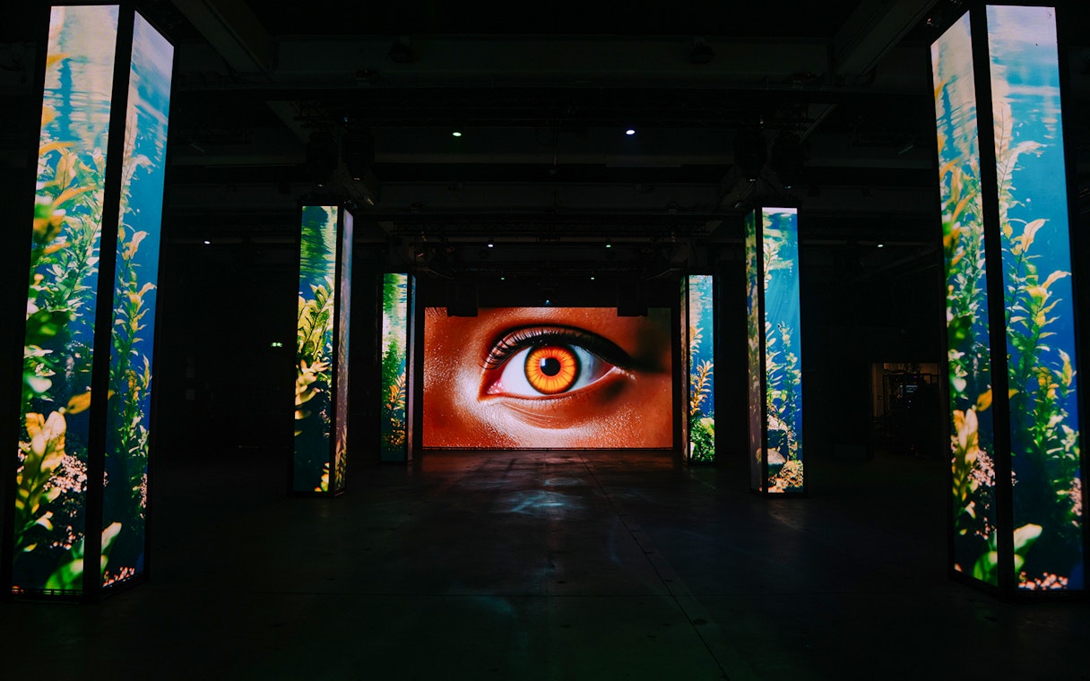 Interactive digital art installation with eye display at Amaze Amsterdam.