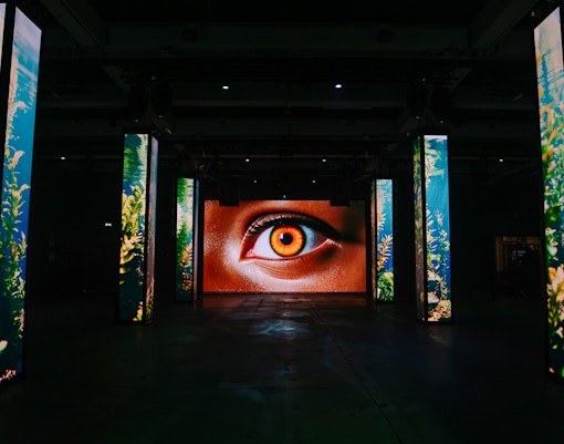 Interactive digital art installation with eye display at Amaze Amsterdam.