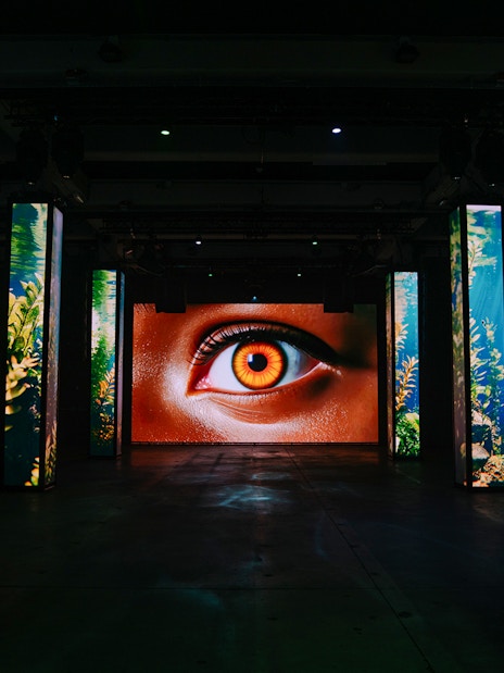 Interactive digital art installation with eye display at Amaze Amsterdam.