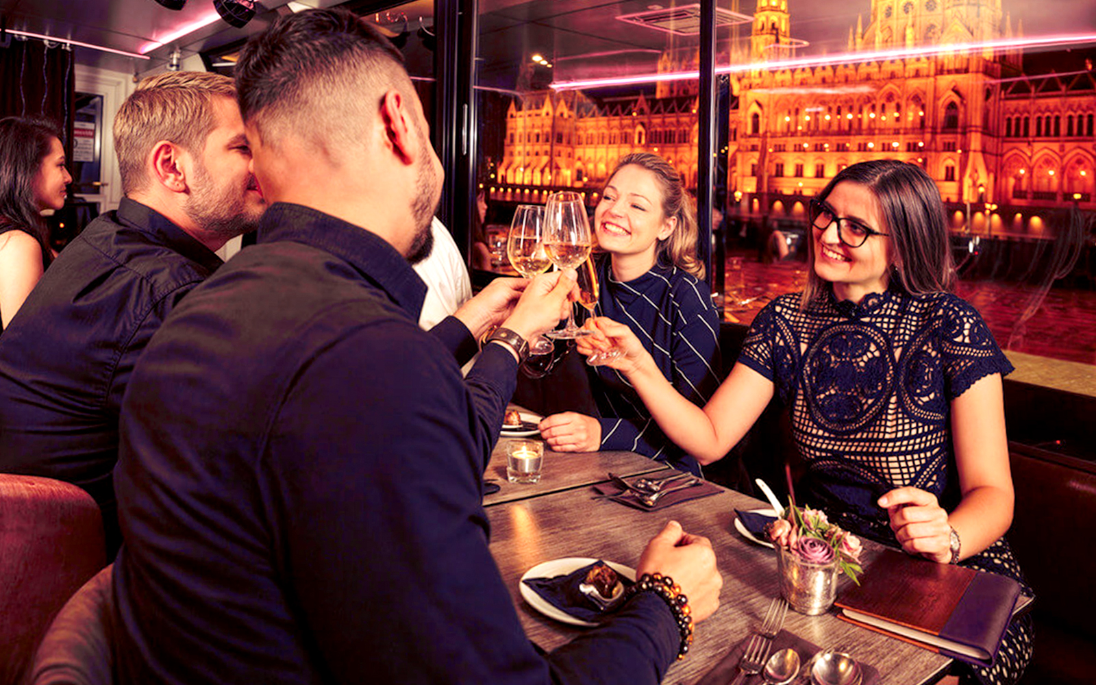 Guests toasting with drinks on Budapest Danube River Dinner & Lights Cruise.