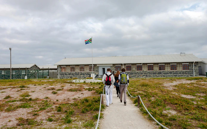 Visitors approaching Robben Island prison museum entrance, South Africa.