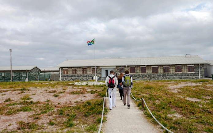 Visitors approaching Robben Island prison museum entrance, South Africa.
